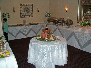 River view Room Banquet, party trays, chafing dish  on a buffet table with with table cloth accented with silver scrolls.