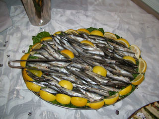 Party tray of fish and lemon wedges.