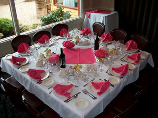 Sunset room banquet set up, pink napkins, servings for 12 tablescape.